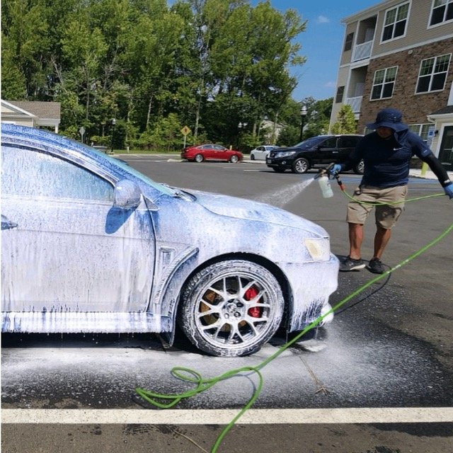 Sports car getting cleaned in driveway